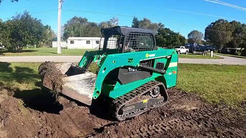 Grading a yard in Florida while on vacation