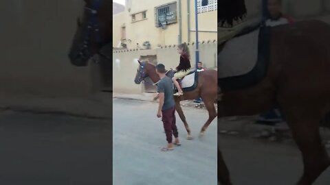 Kenza riding a horse in Sidi Khaled, Algeria