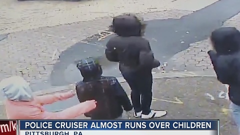 Police car almost slams into children and it's caught on camera