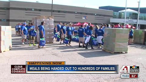 Volunteers hand out meals to hundreds of families