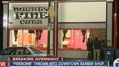 Police are investigating a firebomb thrown through a window at a barber shop