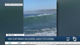 High surf draws onlookers, leads to flooding
