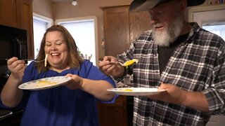 Two Cowboys are Learning to Cook Eggs Sunny Side Up Thanks to Instruction from Meg Tucker