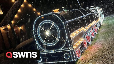 Father and son turn front hedge into incredible polar express themed light display