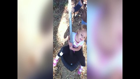 Little Girl gets Dizzy on the Playground