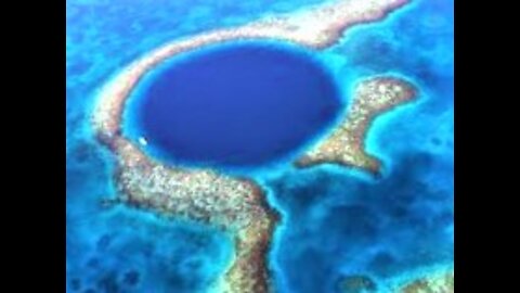 Scuba divers explore the depths of the mysterious Great Blue Hole in Belize
