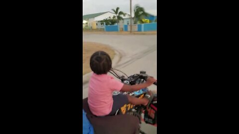 Young Kid Driving A Four Wheeler Bike