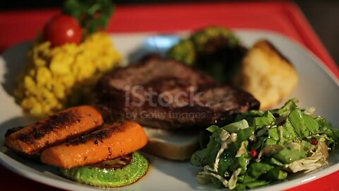 A grilled serving of succulent tender peppered steak garnished with grilled vegetables