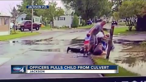 Officer pulls child from culvert in Jackson