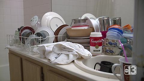 Woman forced to clean dishes in bathtub due to plumbing problems