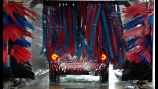 Men take a shower in a car wash