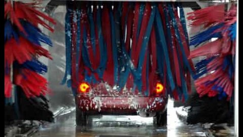 Men take a shower in a car wash