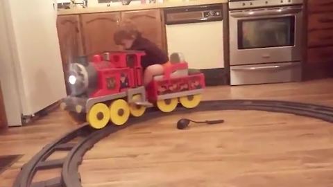 Tot Boy Falls Asleep On A Toy Train