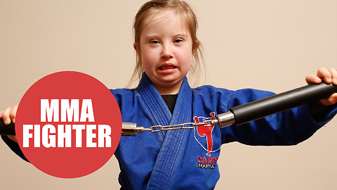 Inspiring eight-year-old who has Down's Syndrome receives black belt in MMA