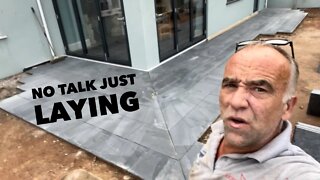 No talking just laying patio tiles