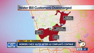 Workers check water meters as complaints continue