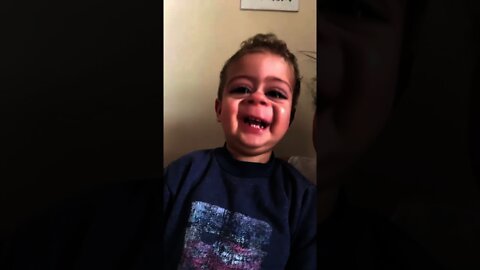 A crying baby immediately starts laughing after he sees a funny video filter on the phone. Priceless