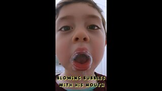 Little Boy Blowing Bubbles with his Mouth