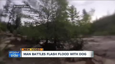 Man battles flash flood with dog