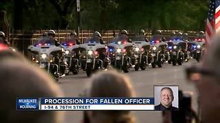 Sirens sound as funeral procession for fallen officer reaches cemetery