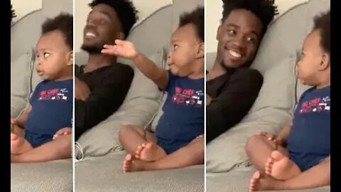 Cute moment little baby having full men conversation with dad while watching tv