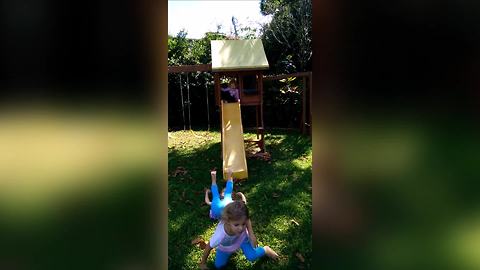 Young Girls Go Down A Slide And Do A Somersault At The Bottom
