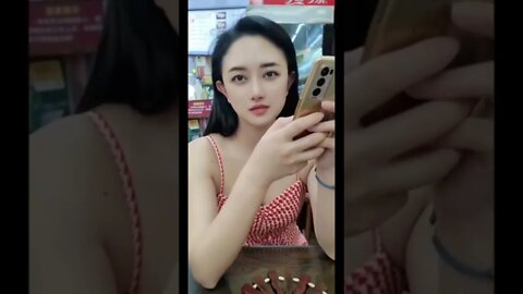 Cute Chinese Girl Caught Looking At Her Phone