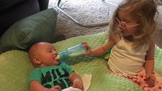 Big sister helps out her baby brother