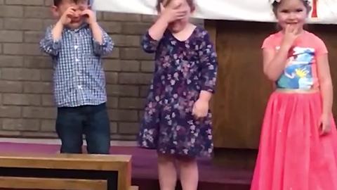 "Little Girl Facepalms when Little Boy Cries at Kids' Concert"