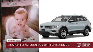 Search for stolen SUV with child inside