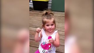 Lovely Tot Girl Blows Bubbles