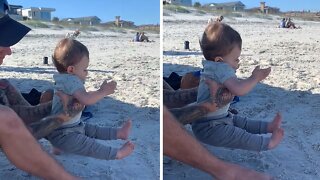 Baby Boy Hilariously Puts His Feet Up Over The Sand