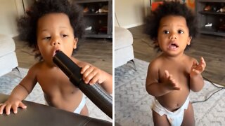 Baby learns the hard way not to play with the vacuum