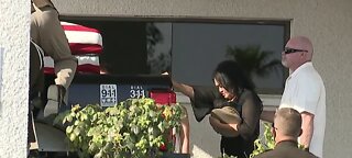 Remembering Lt. Lloyd: Mindy, wife of 22 years, touches casket at start of procession