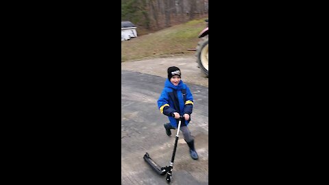 My boy and his scooter.
