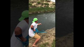 Fishing by net in small river