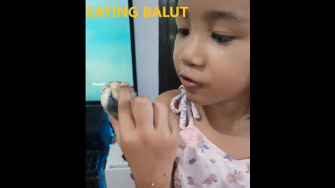 Girl eats balut