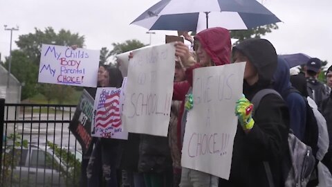 Parents and students protested outside Charlotte middle school and high school Wednesday morning