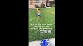 Pitching machine sends whiffle ball straight into kid's face
