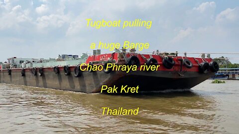 Tugboat pulling a Huge Barge at Chao Phraya river in Thailand