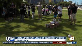 Local artists paint murals on boarded-up windows