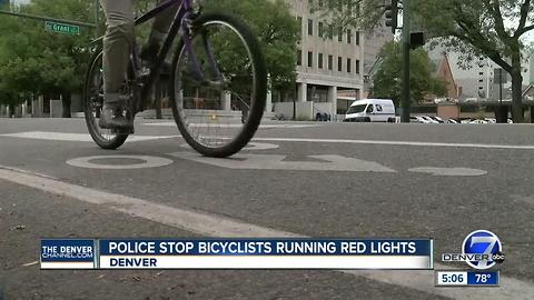 Police stop bicyclists running red lights in Denver