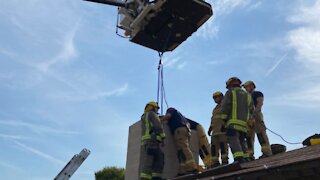 Henderson woman freed by first responders after climbing into chimney