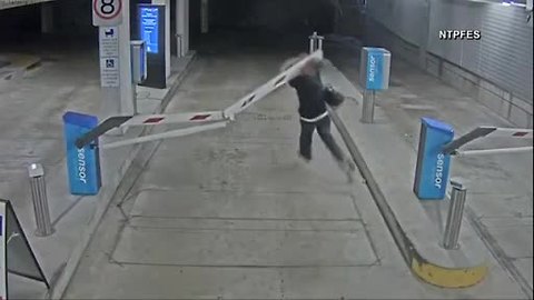 Man on foot plows through parking garage gate in Australia