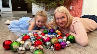 Sofia decorates a Christmas tree