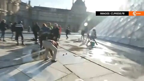 Climate extremist have staged an assault on the Louvre Pyramid in Paris