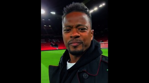 Patrice Evra reviewing the taste of Old Trafford's grass