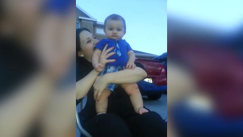 A Baby Boy Frowns While He Watches Fireworks