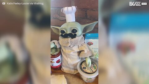 Baby Yoda prepares pizza in a galaxy far, far away