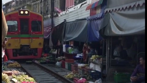 Watch a Train Run Through Thailand’s Most Dangerous Market